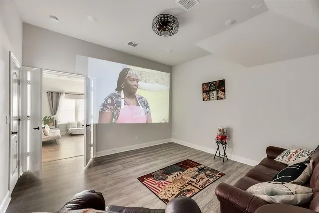 a living room with furniture and wooden floor