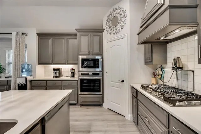 a kitchen with a stove a sink and a refrigerator