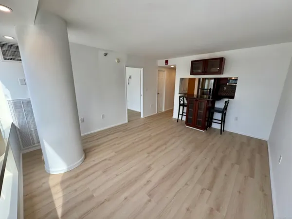 a view of empty room with wooden floor