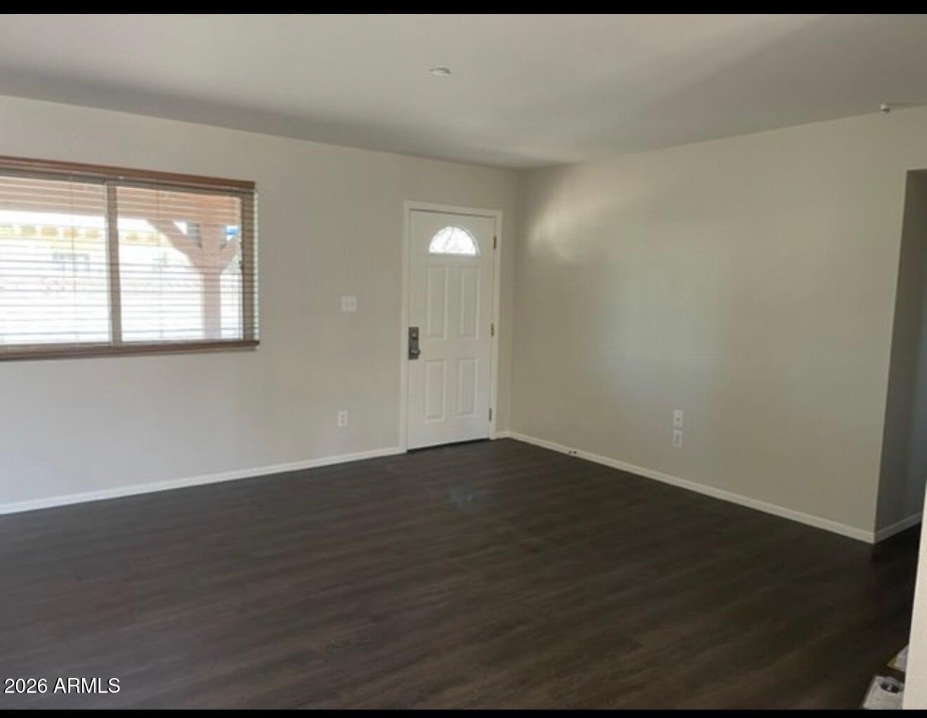 4008 West Laurel Lane Phoenix, AZ 85029 - Photo 4 of 10 an empty room with wooden floor and windows