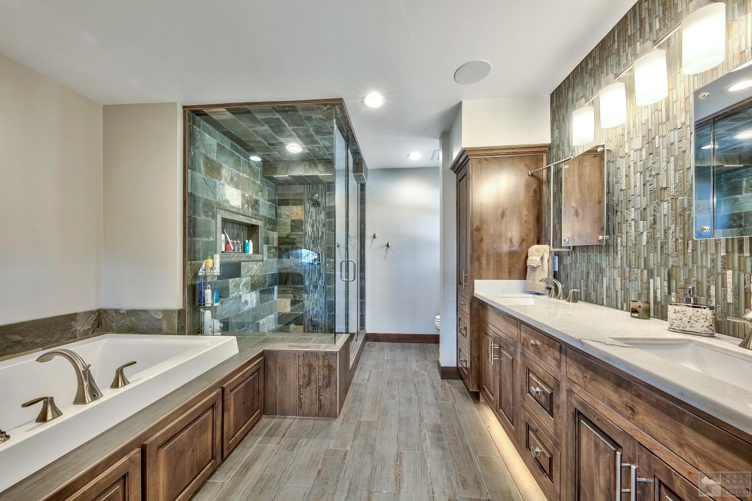 416 Maryanne Drive Stateline, NV 89449 - Photo 17 of 32 a bathroom with a granite countertop tub sink and mirror
