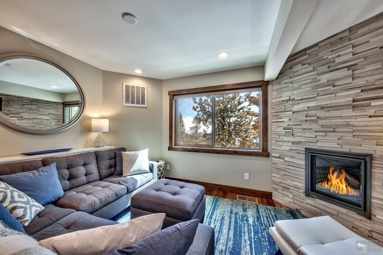 416 Maryanne Drive Stateline, NV 89449 - Photo 19 of 32 a living room with furniture a fireplace and a large window