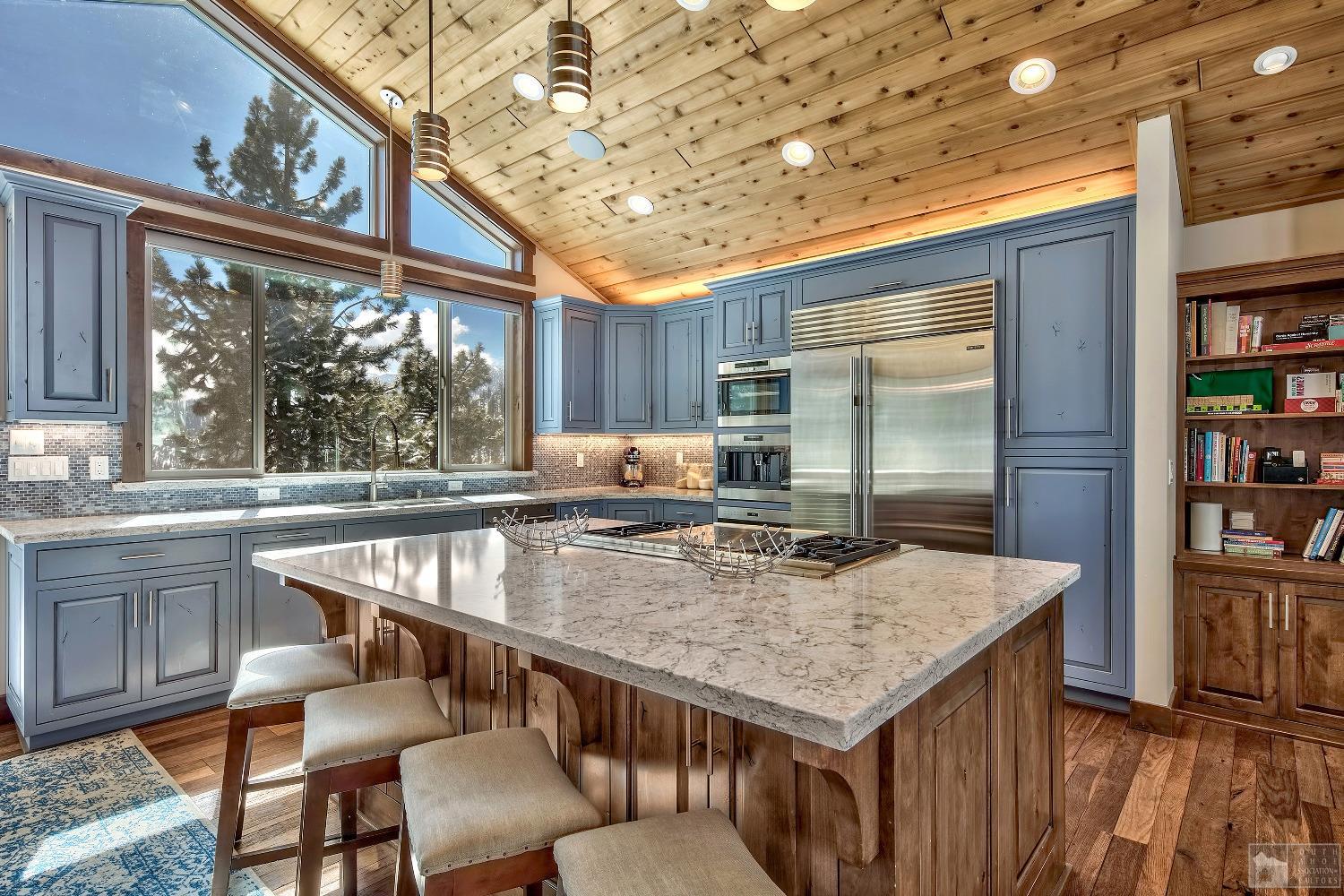 416 Maryanne Drive Stateline, NV 89449 - Photo 5 of 32 a kitchen with a table chairs and refrigerator