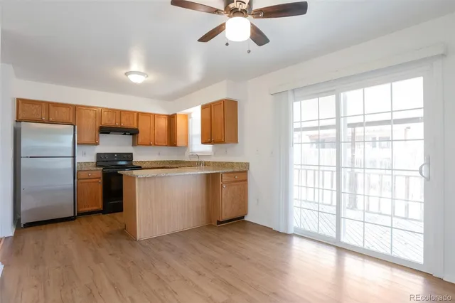 a kitchen with a refrigerator and window