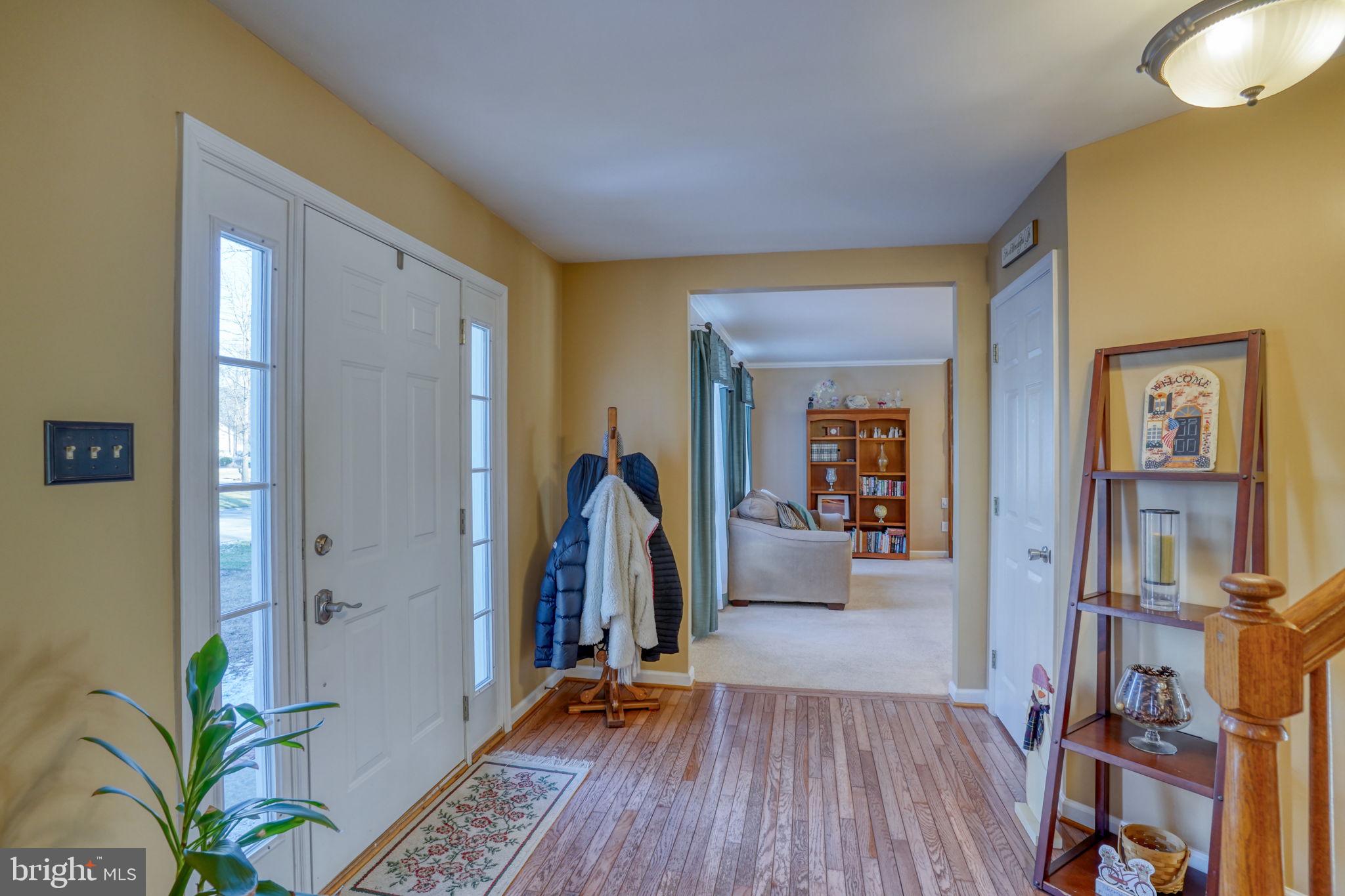108 Burning Tree Road Dover, DE 19904 - Photo 18 of 70 a view of a bedroom with wooden floor and a bookshelf