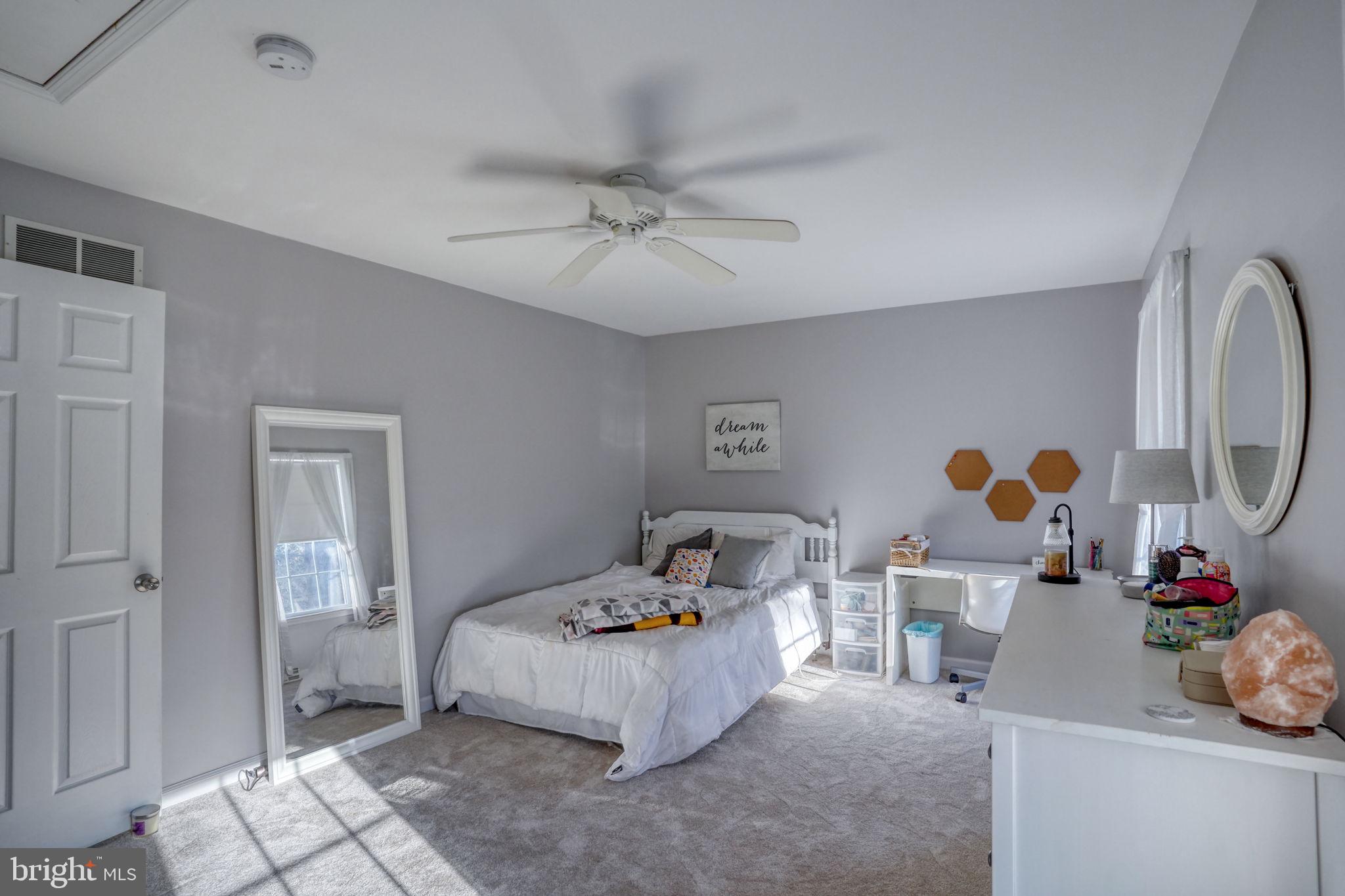 108 Burning Tree Road Dover, DE 19904 - Photo 51 of 70 a bedroom with a bed and cabinets