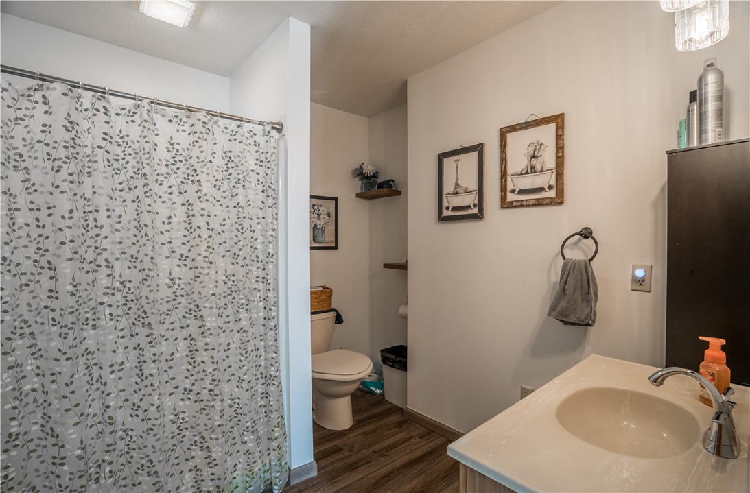 1319 Perry Road Cable, OH 43009 - Photo 24 of 44 This bright bathroom features wood-look flooring and a functional vanity, offering comfort and convenience.