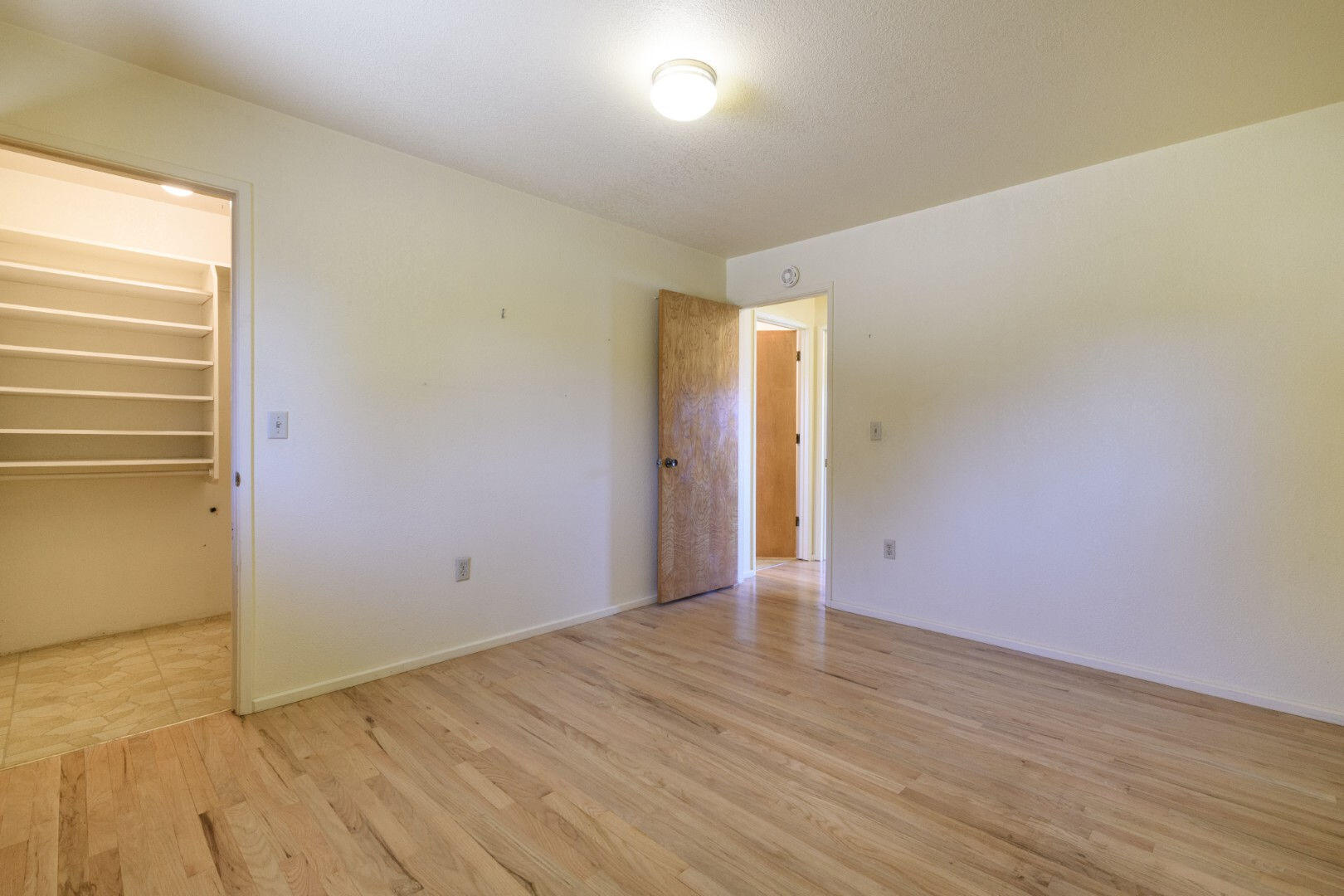 7035 Riverside Drive Redding, CA 96001 - Photo 14 of 23 a view of an empty room with wooden floor and a window