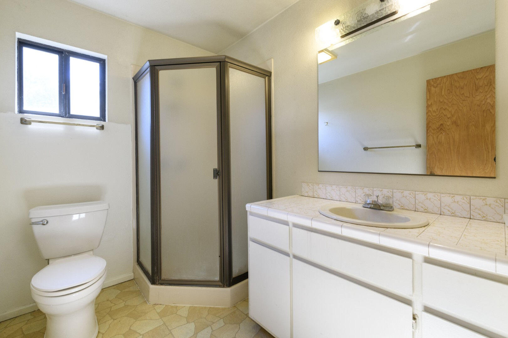7035 Riverside Drive Redding, CA 96001 - Photo 15 of 23 a bathroom with a toilet sink and mirror