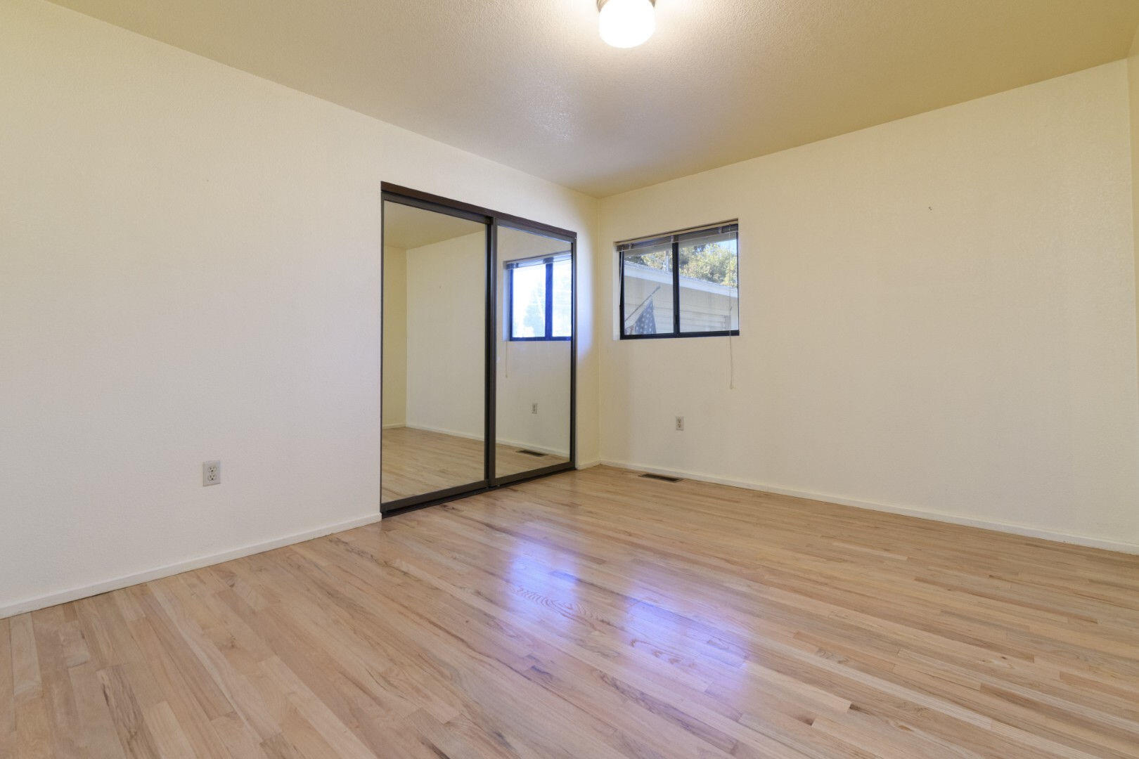 7035 Riverside Drive Redding, CA 96001 - Photo 16 of 23 an empty room with wooden floor and windows