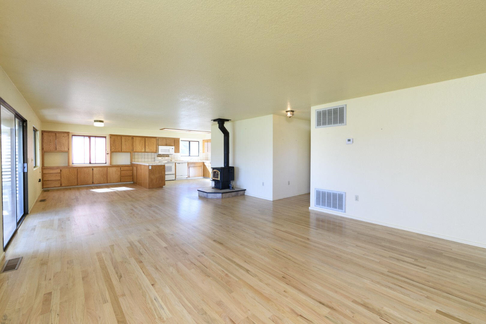 7035 Riverside Drive Redding, CA 96001 - Photo 17 of 23 a view of a big room with wooden floor and windows