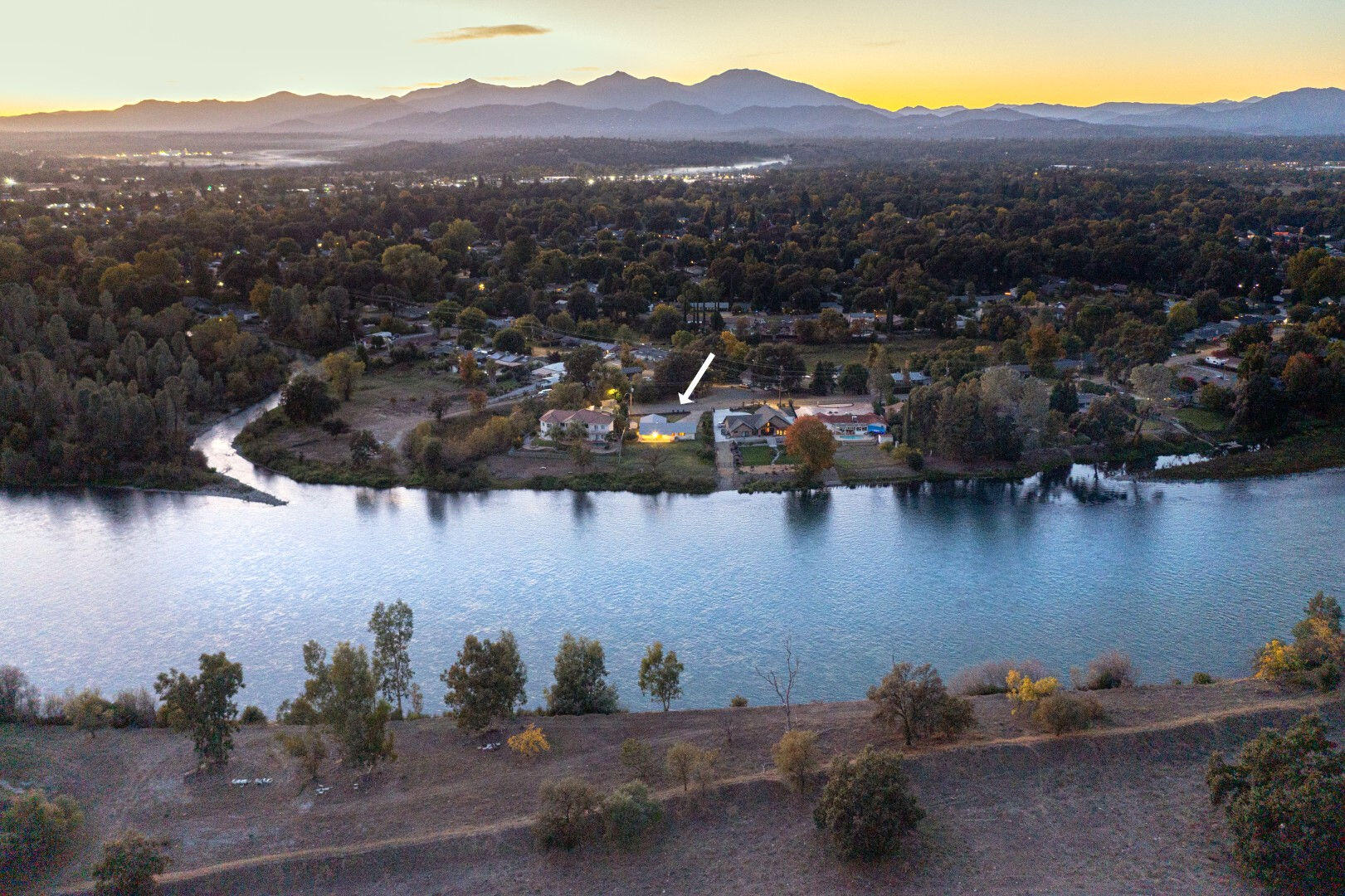 7035 Riverside Drive Redding, CA 96001 - Photo 4 of 23 an aerial view of a house with a lake view