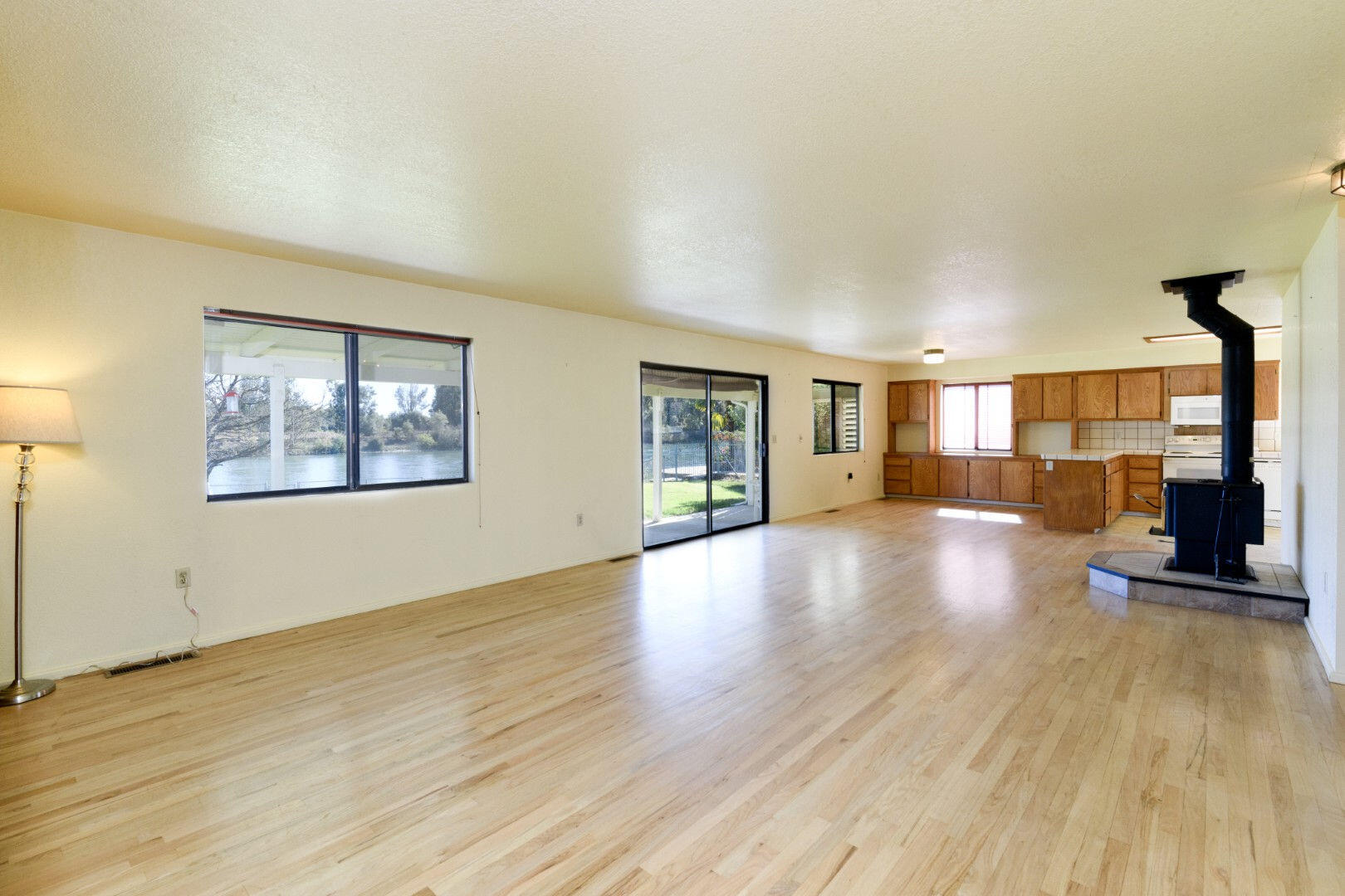 7035 Riverside Drive Redding, CA 96001 - Photo 5 of 23 a view of a livingroom with wooden floor and a large window