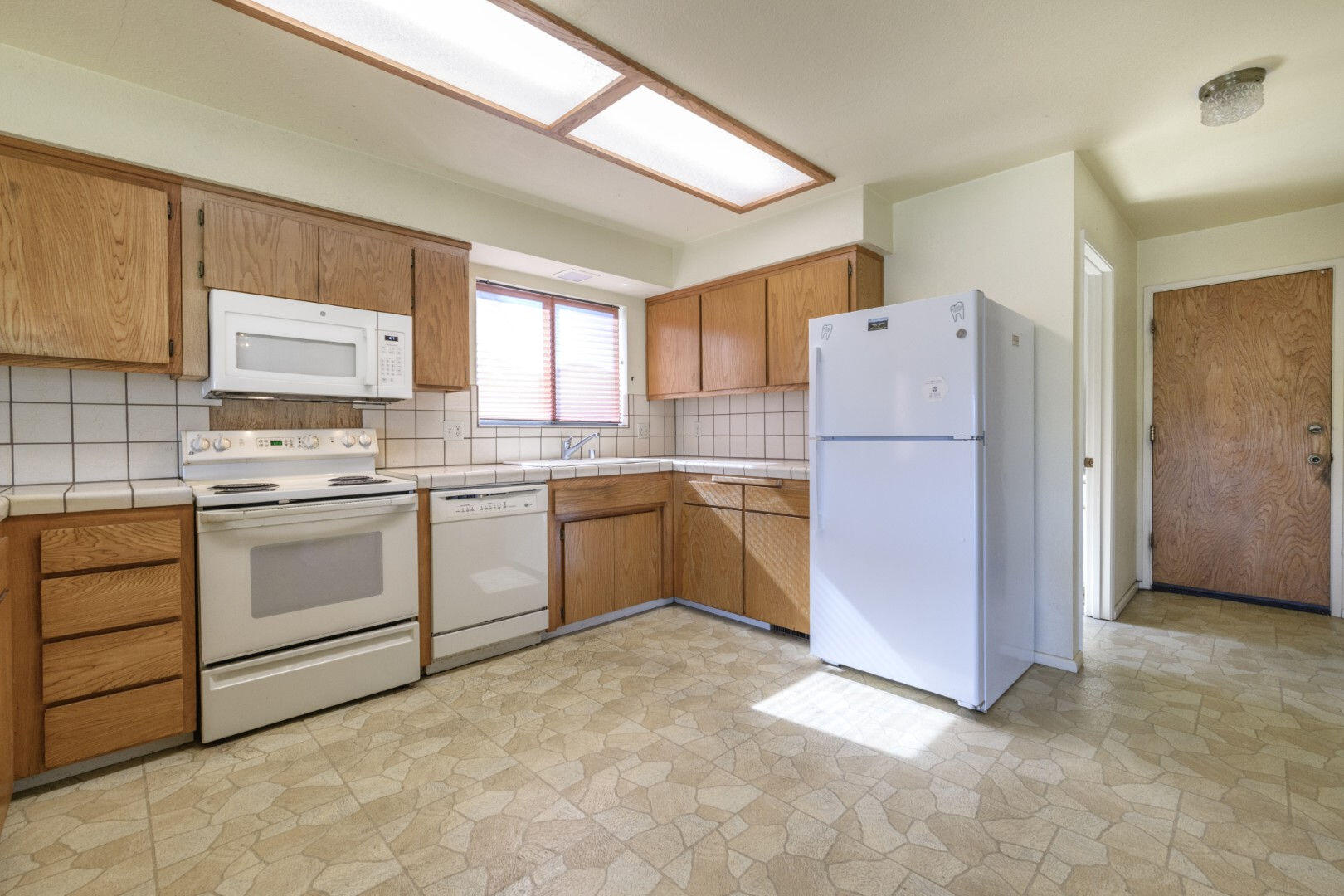 7035 Riverside Drive Redding, CA 96001 - Photo 8 of 23 a kitchen with a white stove refrigerator and cabinets
