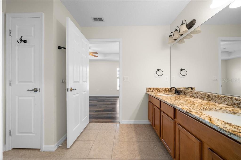 234 Locust Lane Ocala, FL 34472 - Photo 60 of 71 a bathroom with a granite countertop sink a mirror and a shower