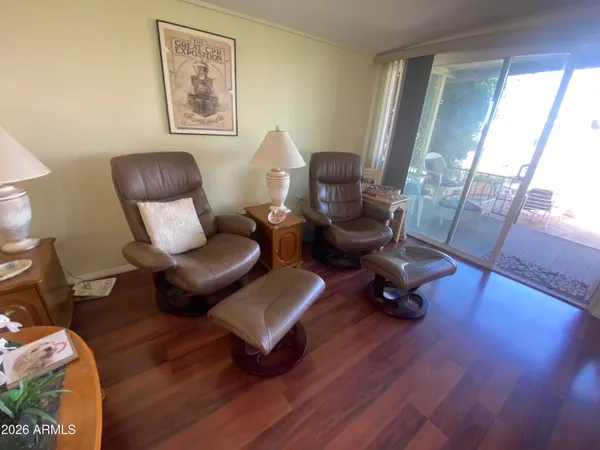 a living room with furniture and a wooden floor