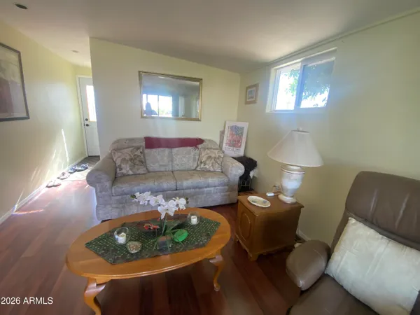 a living room with furniture and a lamp