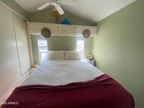 a bedroom with a bed and a window