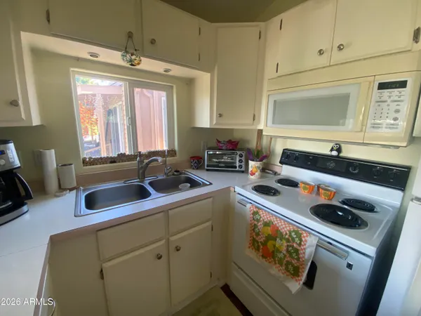a kitchen with a sink stove and cabinets