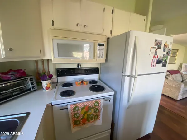 a kitchen with stainless steel appliances a refrigerator sink and cabinets