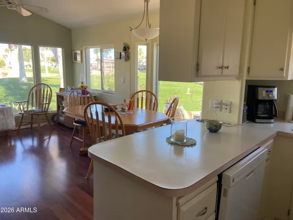 a kitchen with counter space appliances and wooden floor