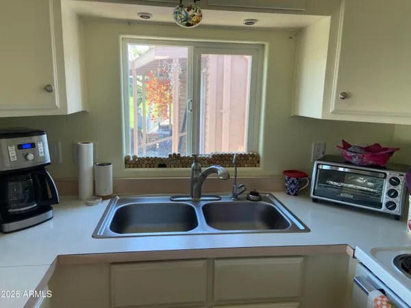 a kitchen with a sink a stove and a window