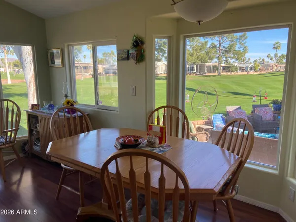 a view of a dining room with furniture a chandelier and wooden floor