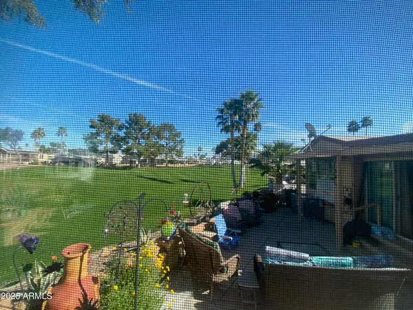 a view of a patio with table and chairs potted plants with lake view