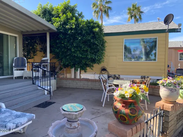 a view of a chairs and table in backyard