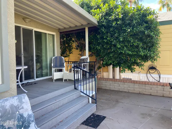 a view of a house with backyard and sitting area