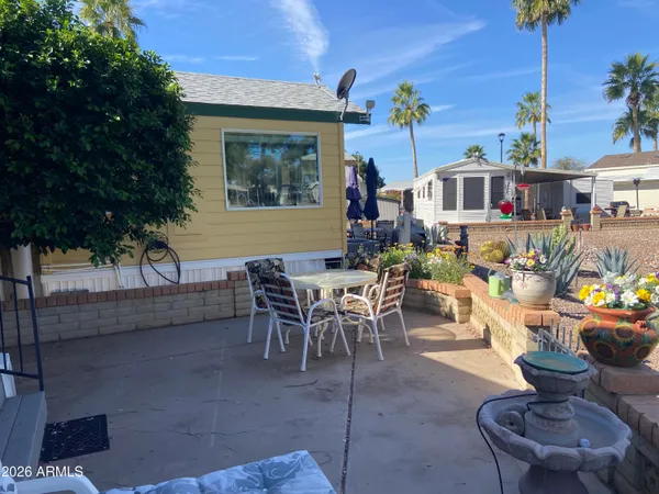 a view of a patio with couches table and chairs and potted plants