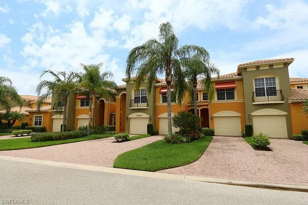 a front view of multiple houses with yard