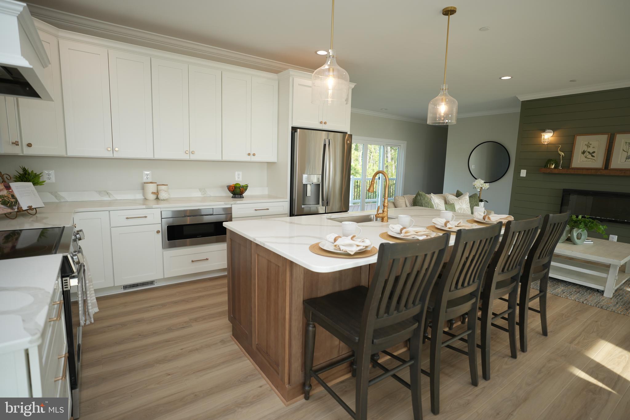 16394 Thomas Road Piney Point, MD 20674 - Photo 18 of 53 a kitchen with a table chairs sink and cabinets