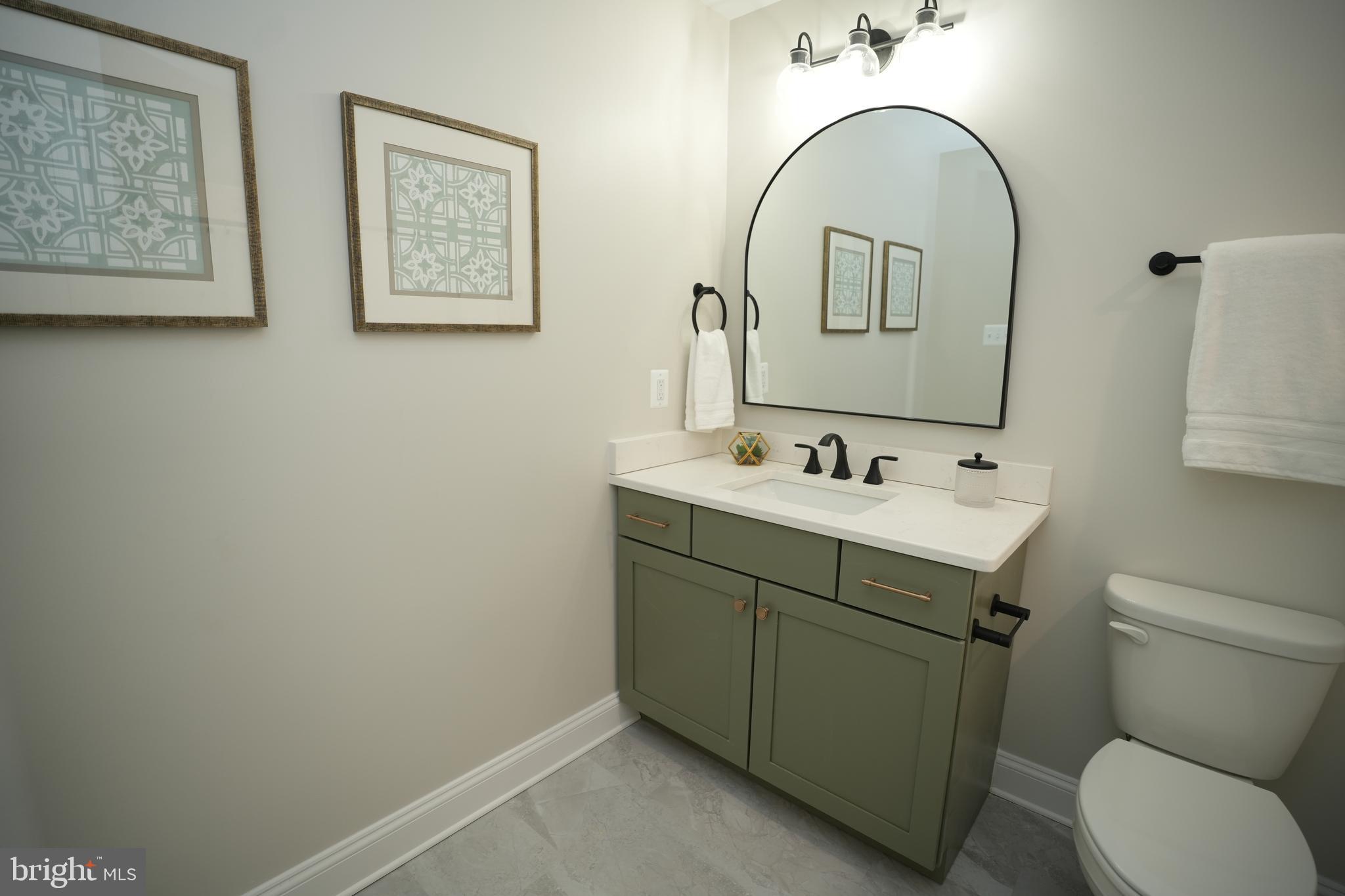 16394 Thomas Road Piney Point, MD 20674 - Photo 25 of 53 a bathroom with a toilet sink and mirror
