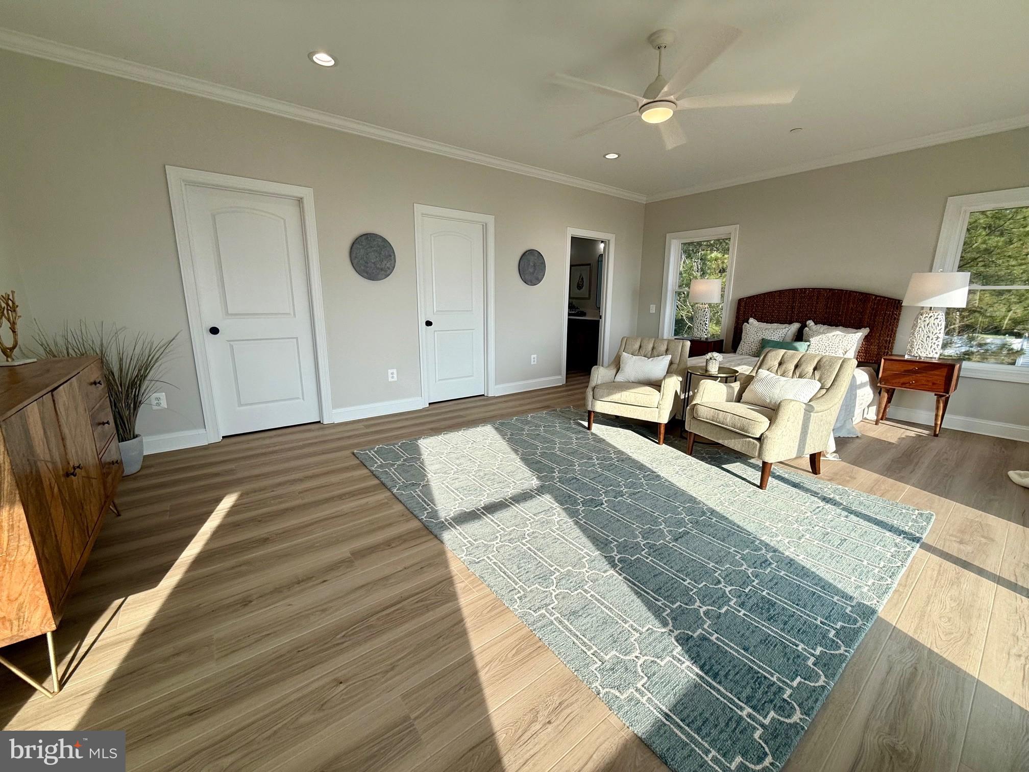 16394 Thomas Road Piney Point, MD 20674 - Photo 28 of 53 a spacious bedroom with a bed a rug and wooden floor