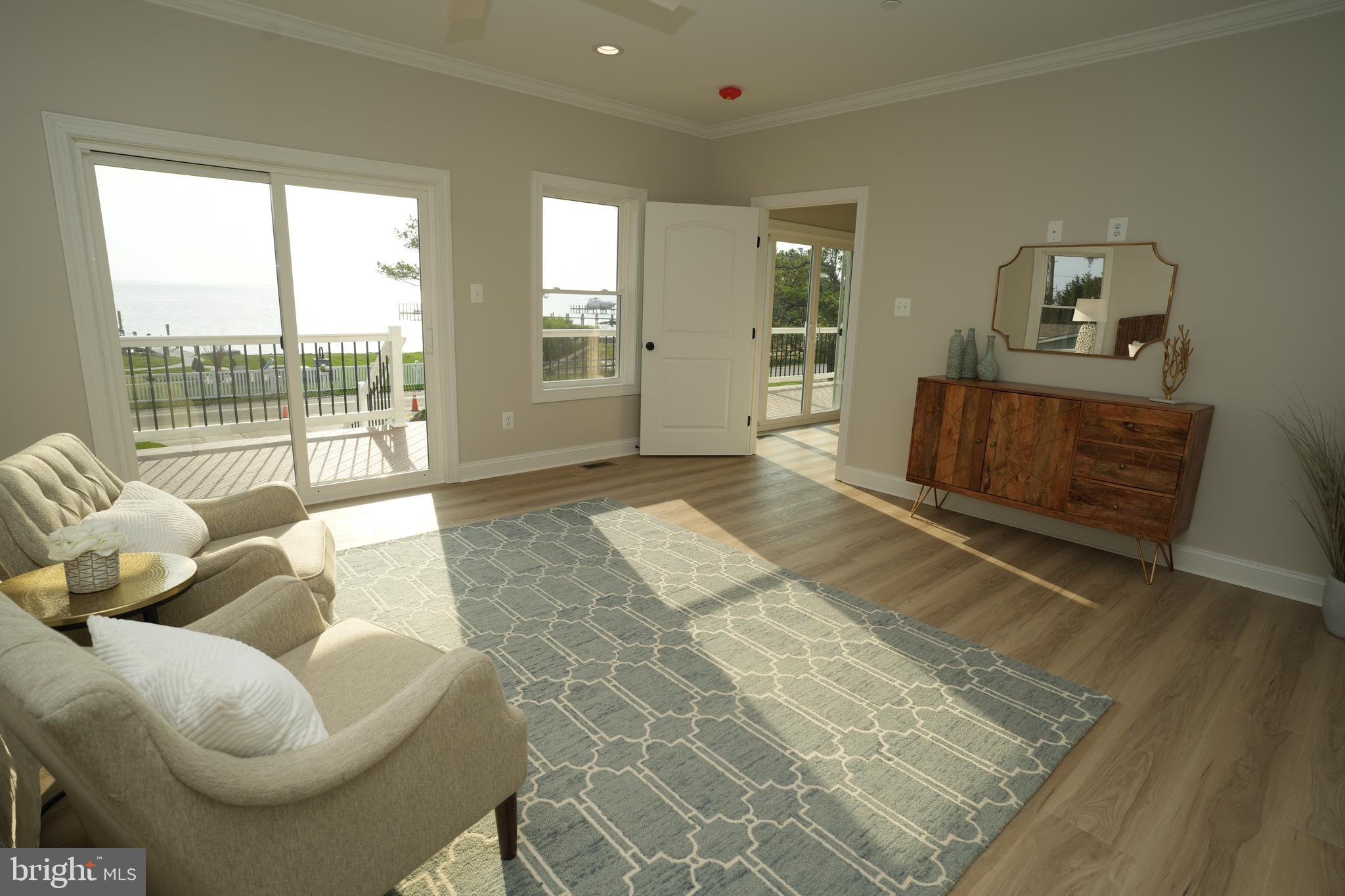 16394 Thomas Road Piney Point, MD 20674 - Photo 29 of 53 a living room with furniture and a floor to ceiling window