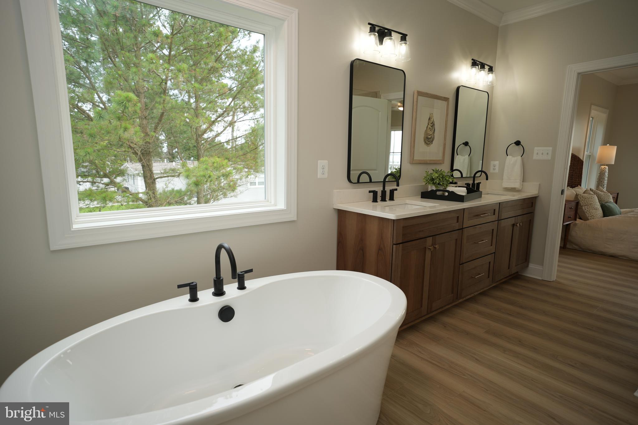 16394 Thomas Road Piney Point, MD 20674 - Photo 31 of 53 a bathroom with a double vanity sink a mirror and a bathtub