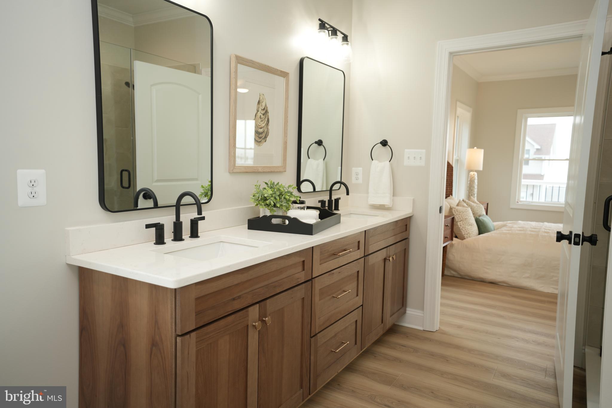 16394 Thomas Road Piney Point, MD 20674 - Photo 32 of 53 a spacious bathroom with a double vanity sink and mirror