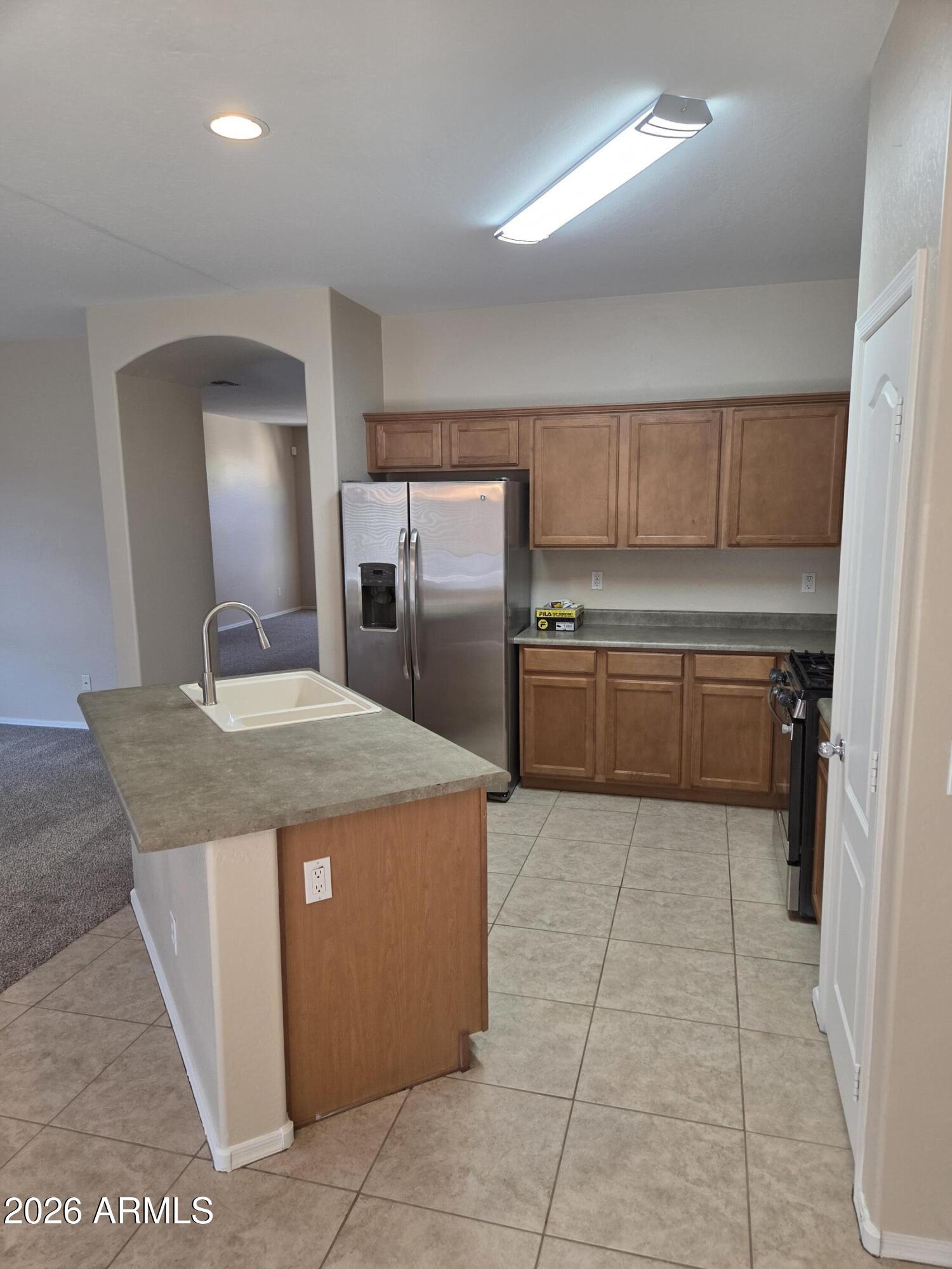 14195 West Hearn Road Surprise, AZ 85379 - Photo 12 of 23 a kitchen with kitchen island granite countertop a sink a counter top space and cabinets