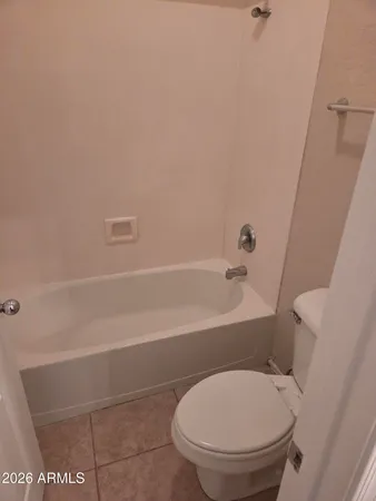 a bathroom with a toilet and a bathtub