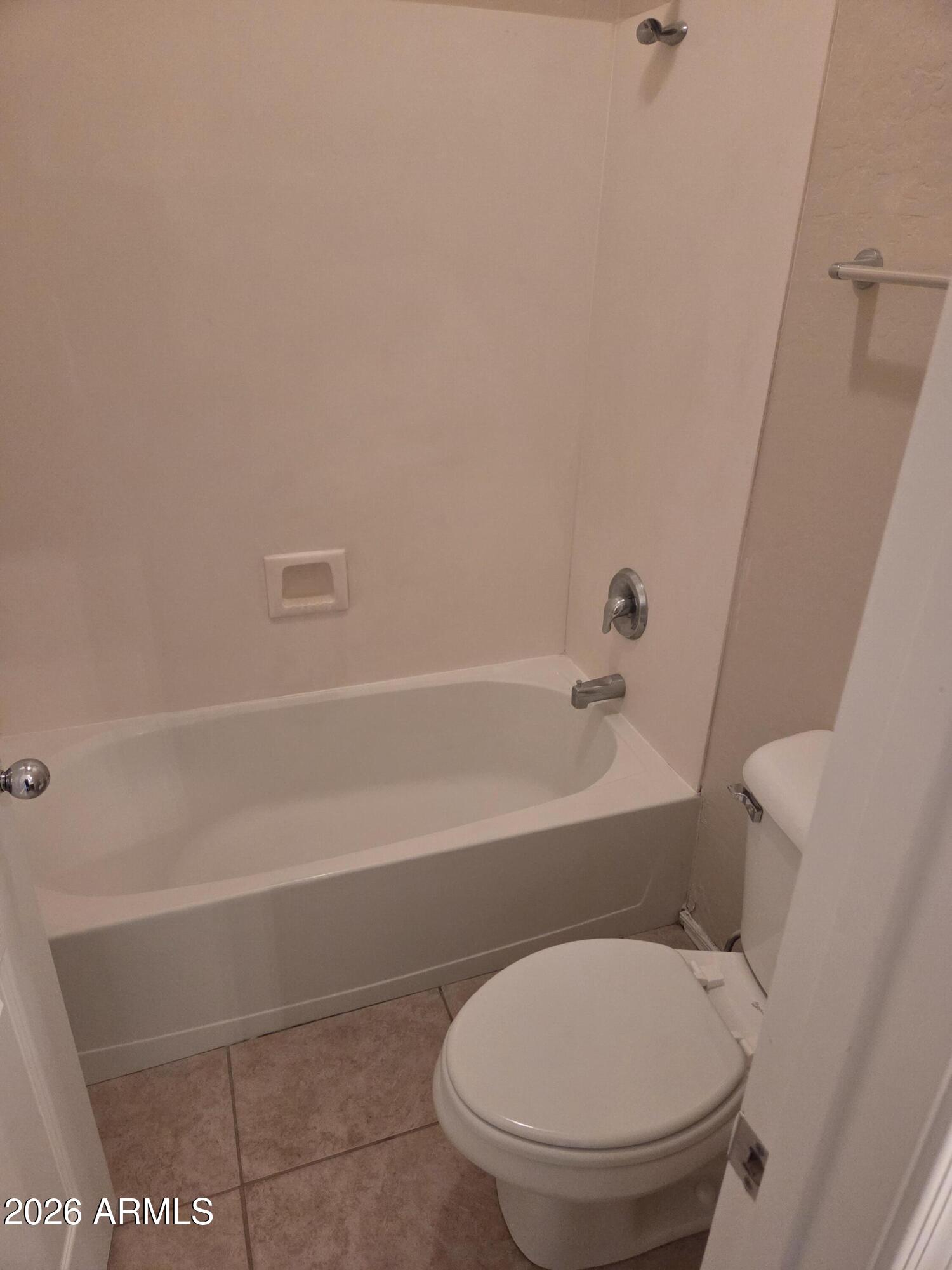 14195 West Hearn Road Surprise, AZ 85379 - Photo 17 of 23 a bathroom with a toilet and a bathtub