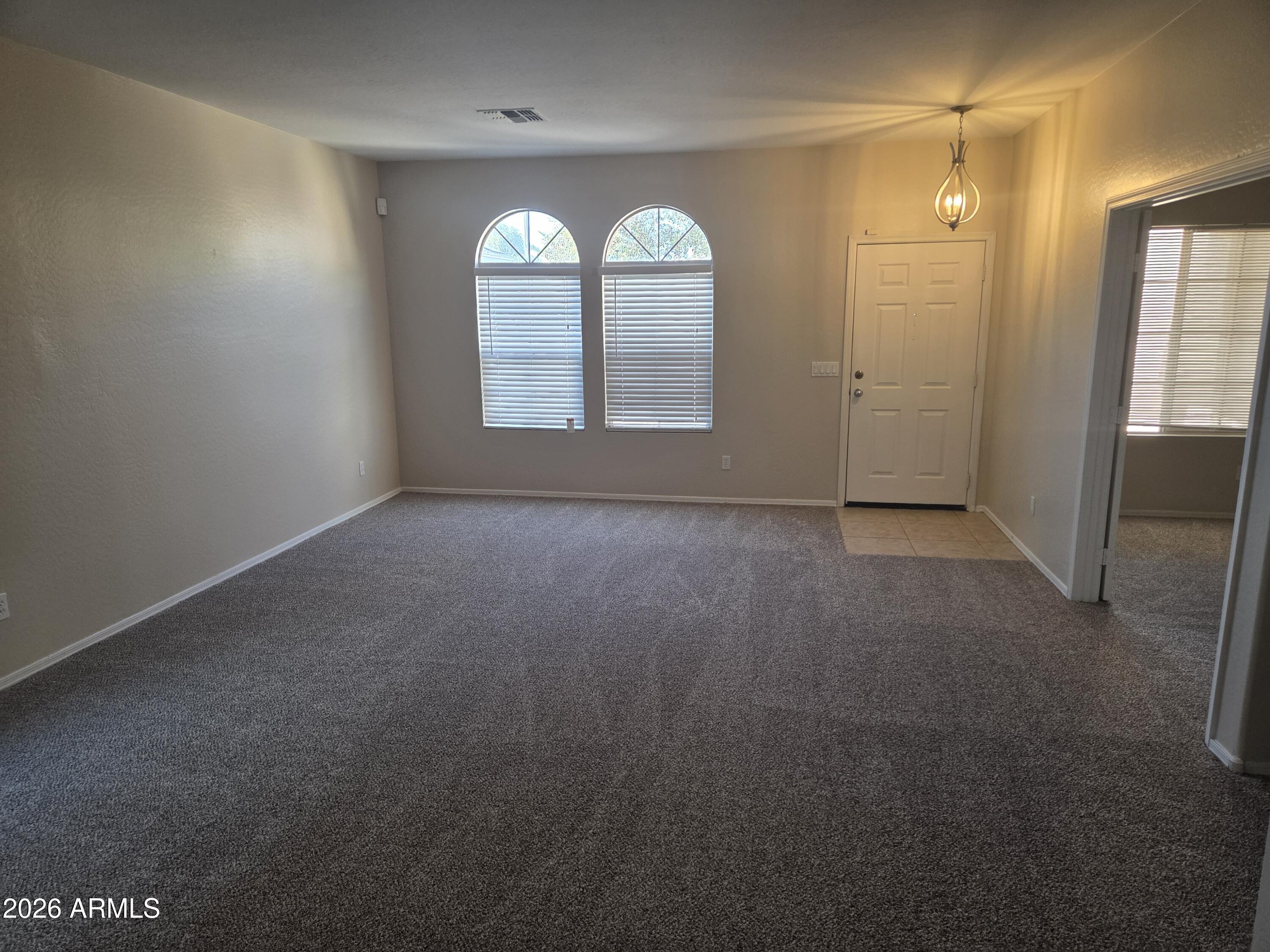 14195 West Hearn Road Surprise, AZ 85379 - Photo 6 of 23 a view of empty room with windows