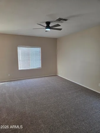 a view of a livingroom with a ceiling fan and window