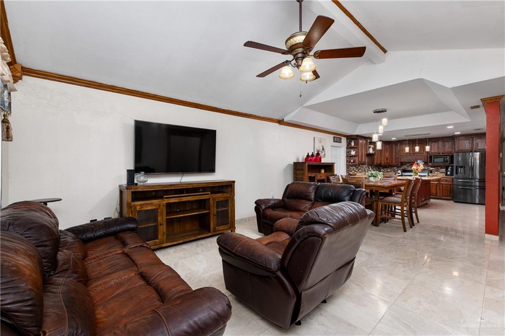 118 J R Becerra Avenue Progreso, TX 78596 - Photo 3 of 17 a living room with furniture and a flat screen tv