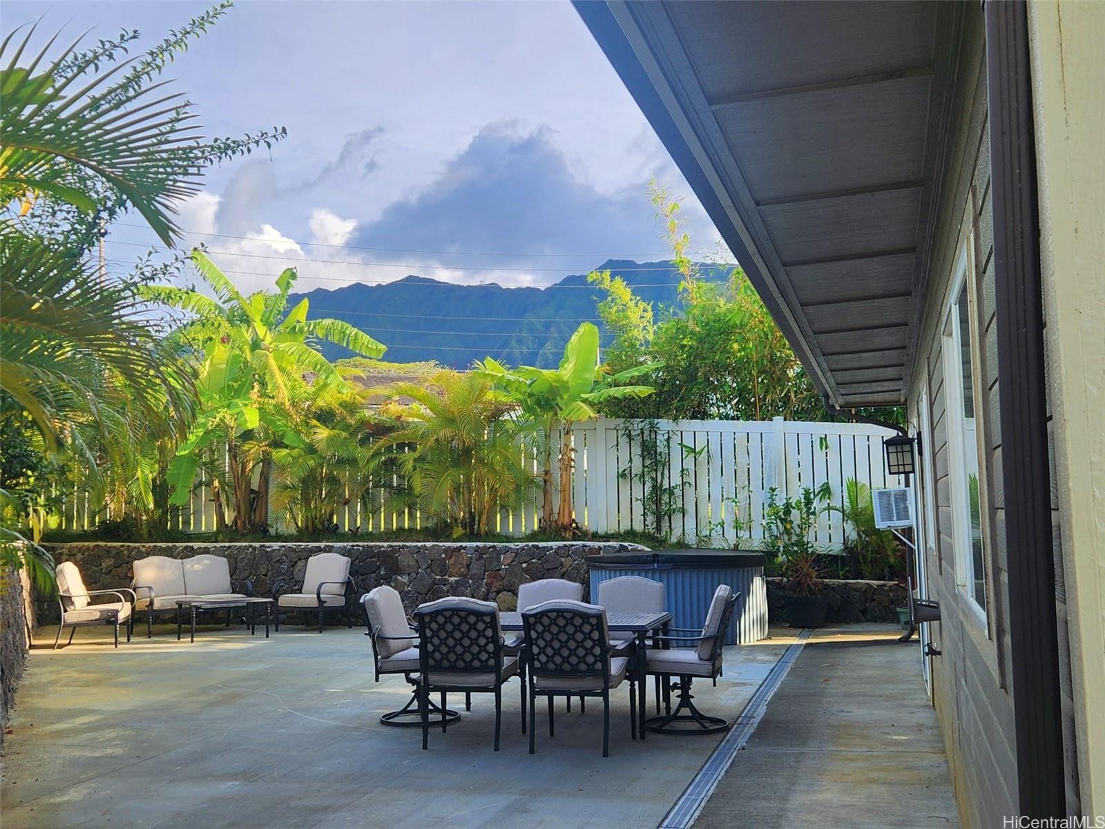 47-285 Waihee Road, Unit D Kaneohe, HI 96744 - Photo 18 of 25 a view of a chairs and table in patio with a yard