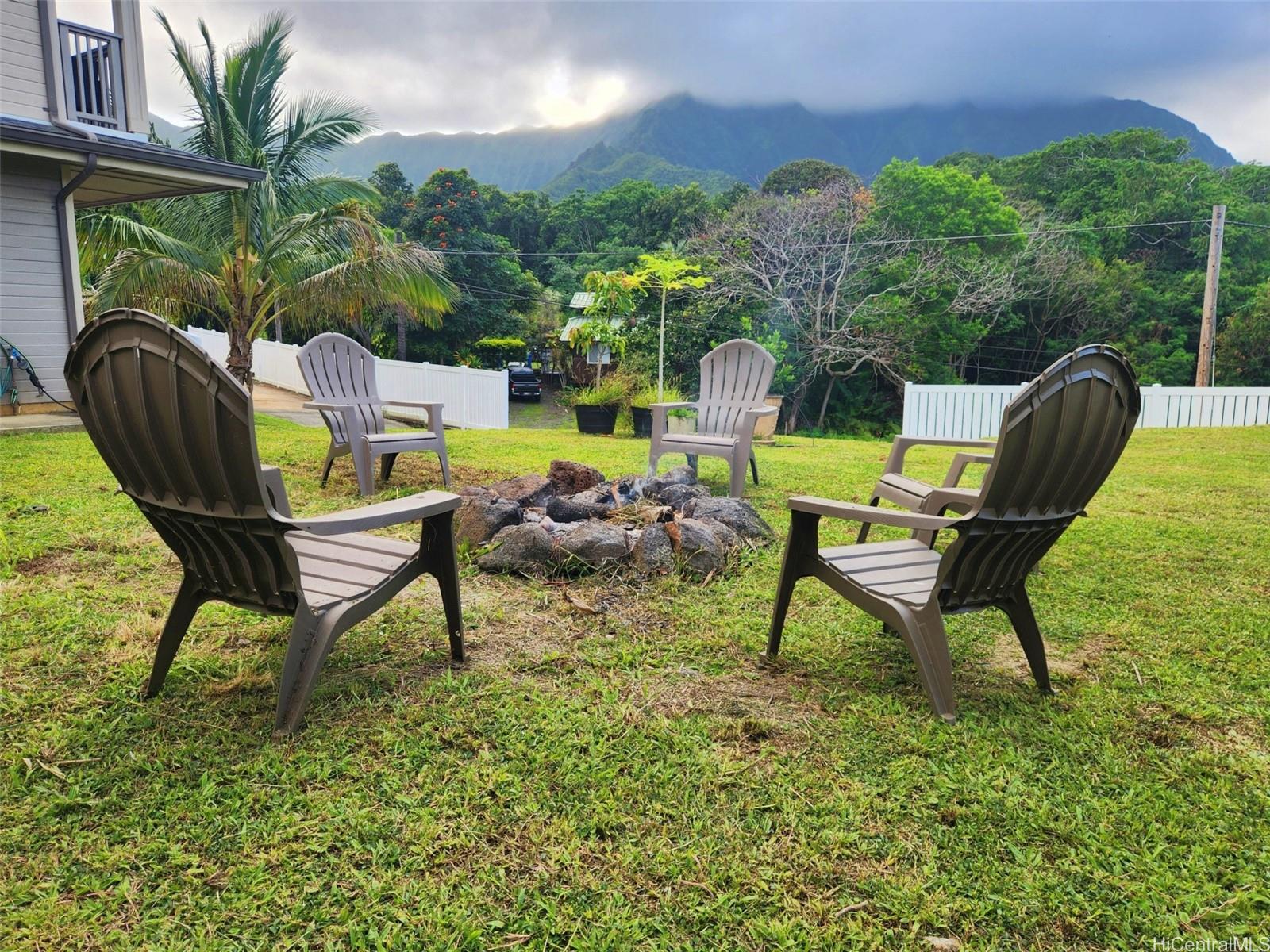 47-285 Waihee Road, Unit D Kaneohe, HI 96744 - Photo 20 of 25 a swimming pool with outdoor seating and yard