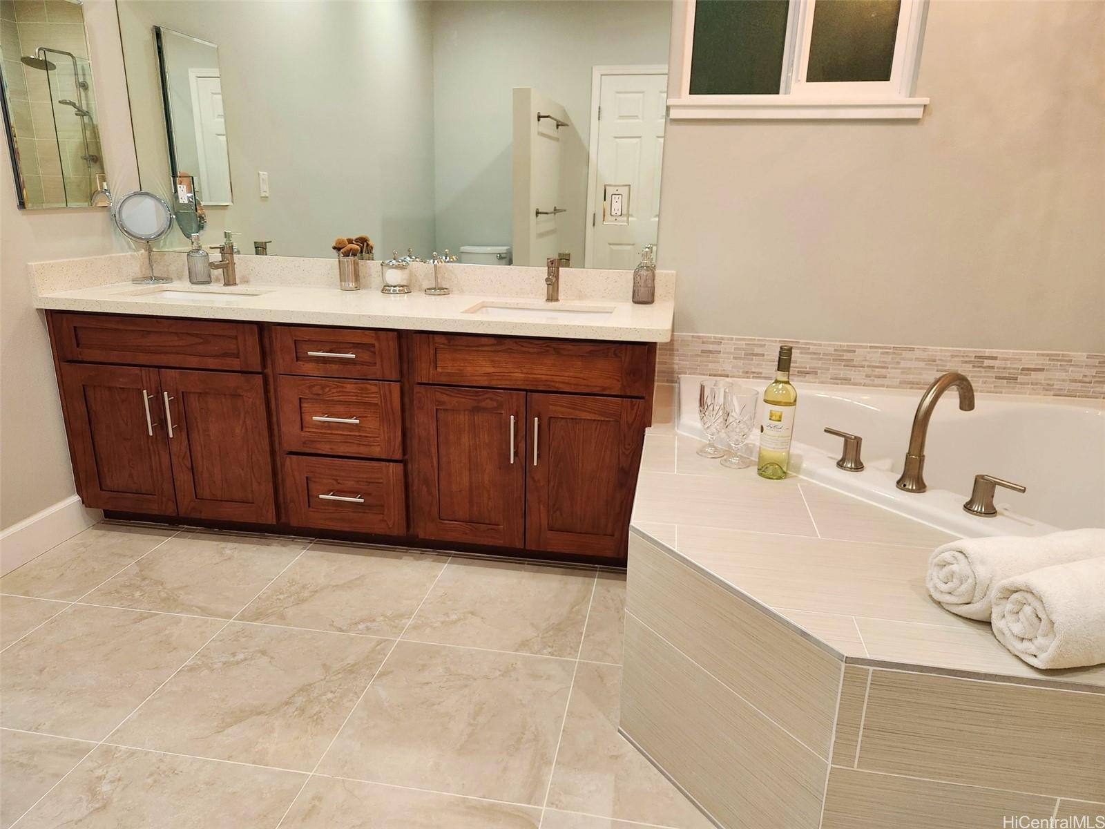 47-285 Waihee Road, Unit D Kaneohe, HI 96744 - Photo 10 of 25 a bathroom with a tub sink and mirror