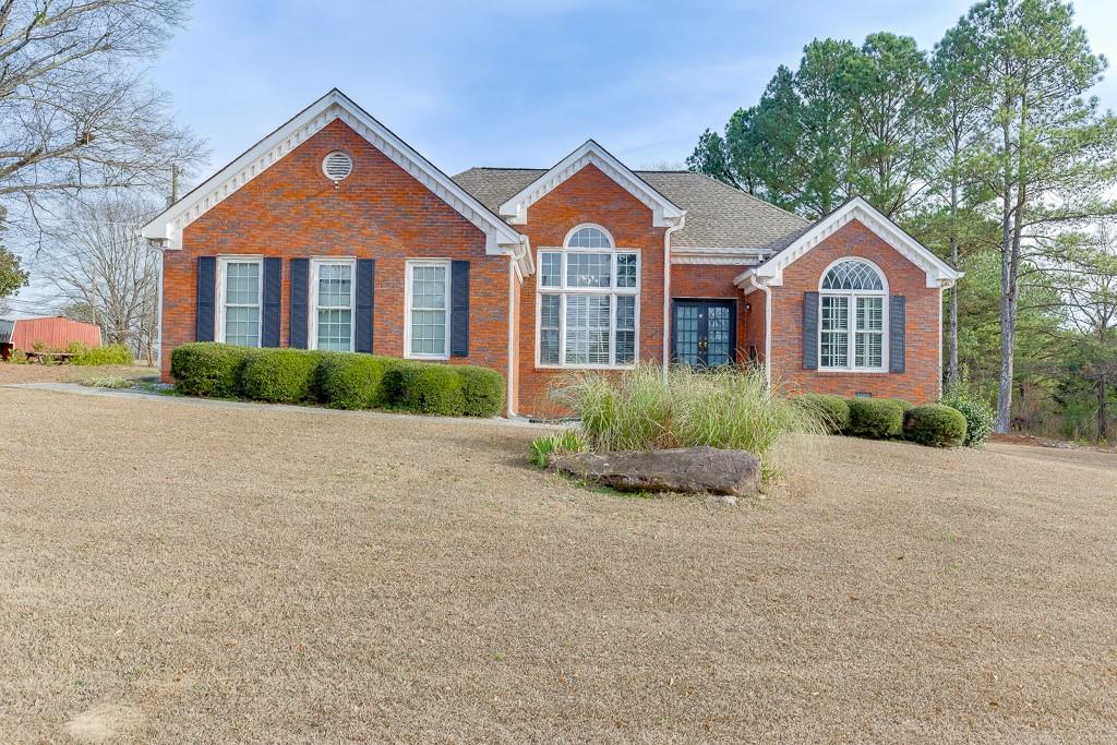 1262 Bowman Road Lawrenceville, GA 30045 - Photo 1 of 32 a front view of a house with a garden