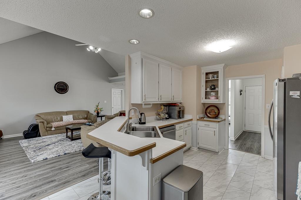 1262 Bowman Road Lawrenceville, GA 30045 - Photo 14 of 32 a kitchen with a sink appliances and cabinets