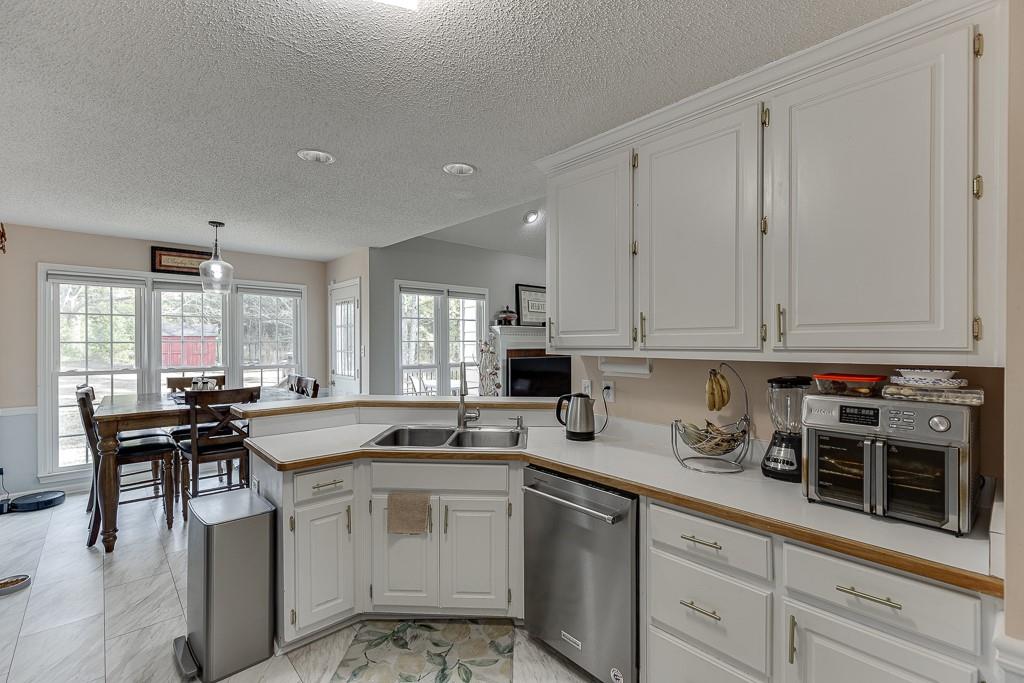 1262 Bowman Road Lawrenceville, GA 30045 - Photo 15 of 32 a kitchen with a sink stove and cabinets